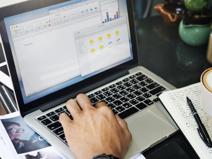 Man writing content on a laptop