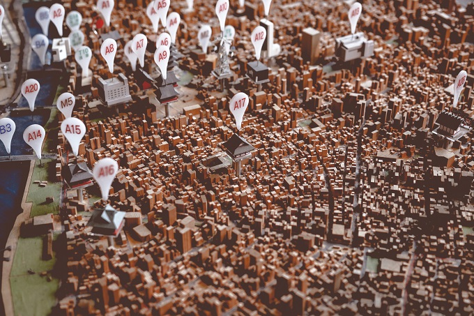 Overhead view of model town with signposts to multiple locations